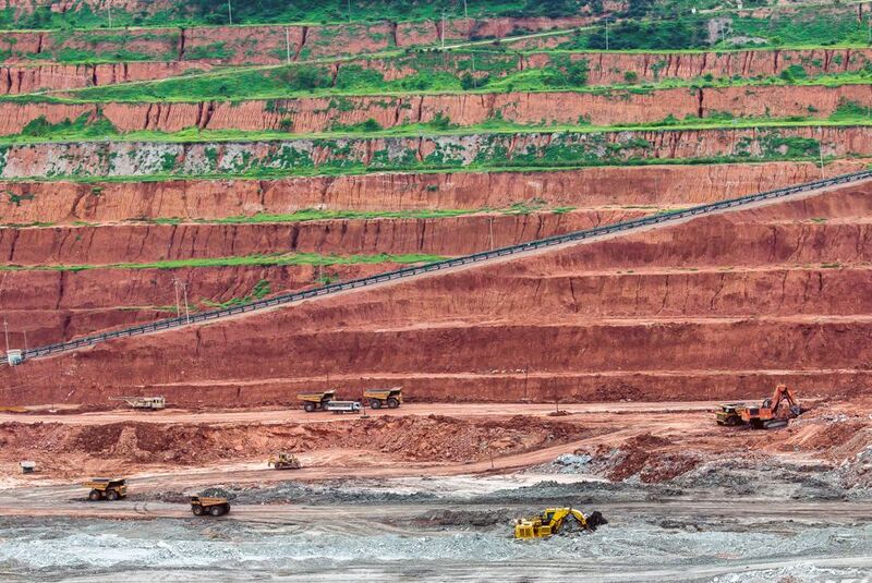 Heavy machinery extracting resources using strip mining